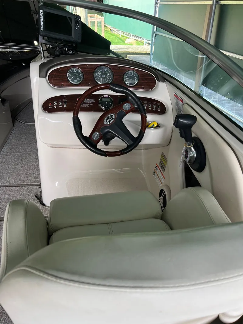 Slide: The Image of 2008 Sea Ray 240 Sundeck helm with steering wheel and instrument panel. - 18