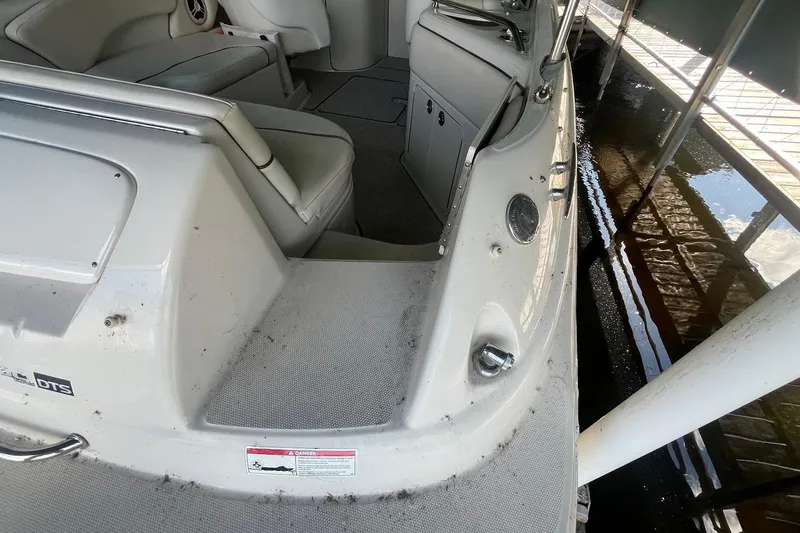 Slide: The Image of 2008 Sea Ray 240 Sundeck interior, showing seating and deck details. - 2