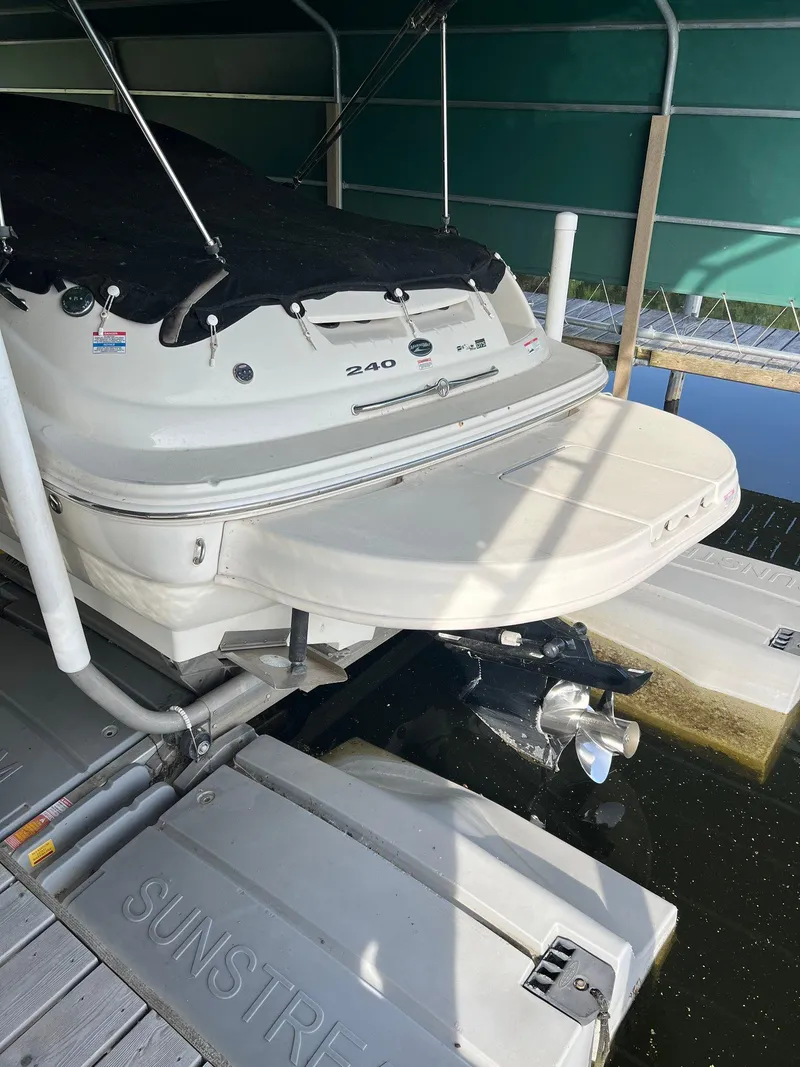 Slide: The Image of 2008 Sea Ray 240 Sundeck boat docked on a Sunstream lift. - 24