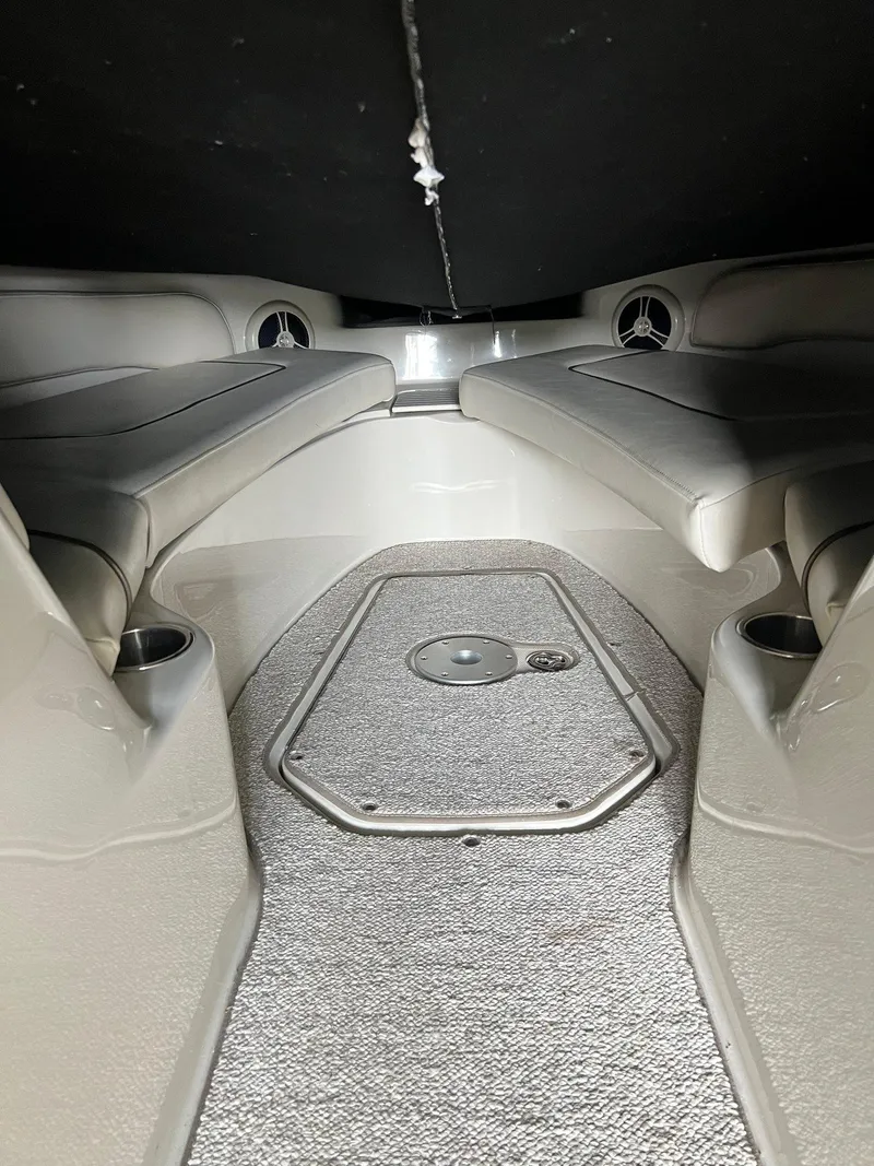 Slide: The Image of Interior of a 2008 Sea Ray 240 Sundeck boat with cushioned seating. - 25