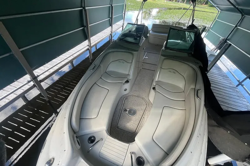 Slide: The Image of 2008 Sea Ray 240 Sundeck boat interior under canopy, featuring spacious seating. - 29
