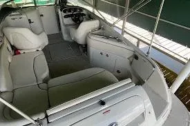 Slide: The Image of 2008 Sea Ray 240 Sundeck interior with white seating and steering console. - 3