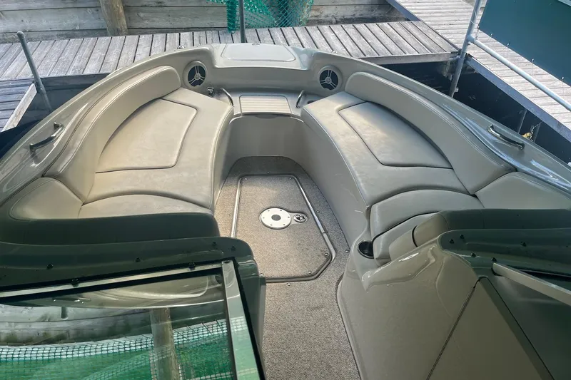 Slide: The Image of 2008 Sea Ray 240 Sundeck interior with spacious seating and carpeted flooring. - 34