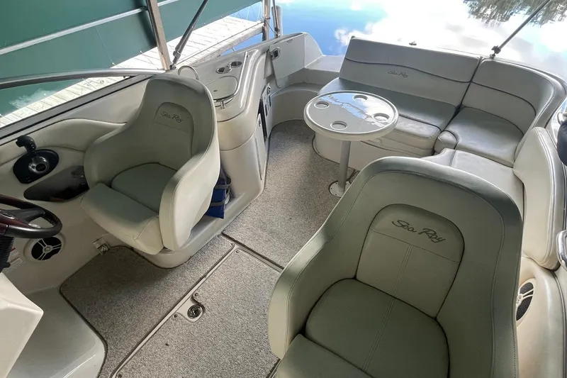 Slide: The Image of 2008 Sea Ray 240 Sundeck interior with seating, table, and helm station. - 5