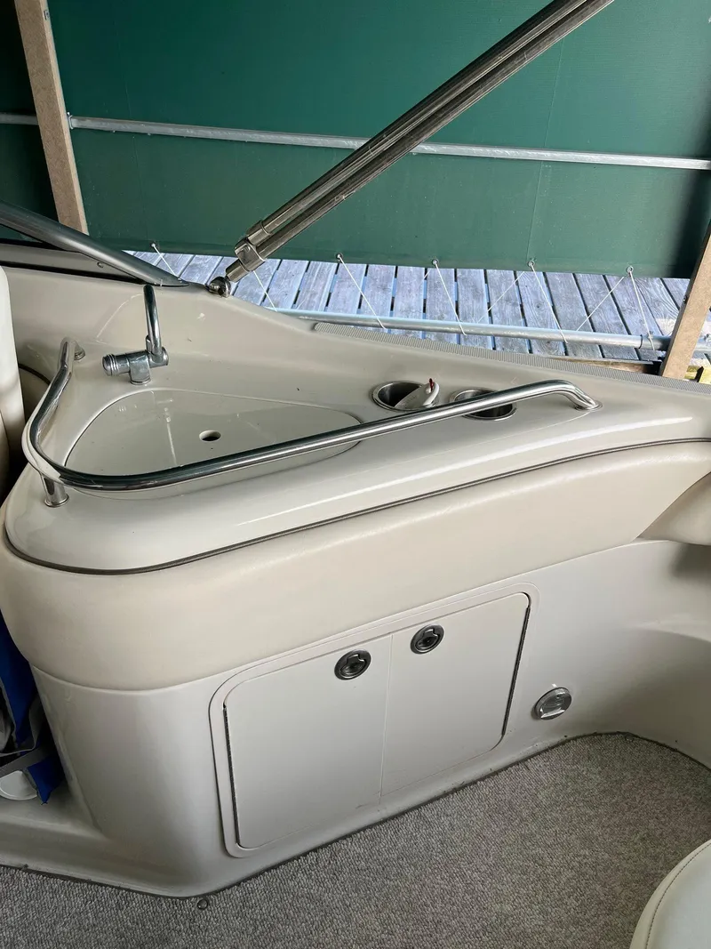 Slide: The Image of 2008 Sea Ray 240 Sundeck interior with sink and storage compartment. - 9