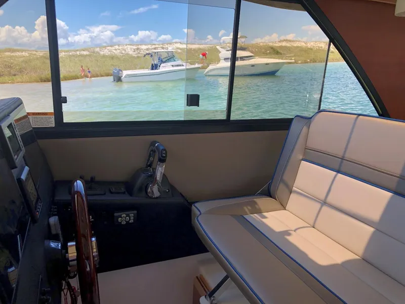 Slide: The Image of Interior view of 2025 Cutwater C-32 Sedan with scenic water backdrop. - 22