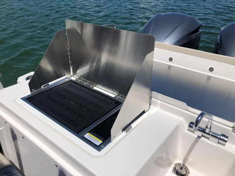 Slide: The Image of Outdoor grill on 2025 Cutwater C-32 Sedan boat, near water. - 9