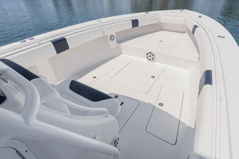 Slide: The Image of 2019 Fountain 38 CC boat interior with white seating and storage compartments. - 36