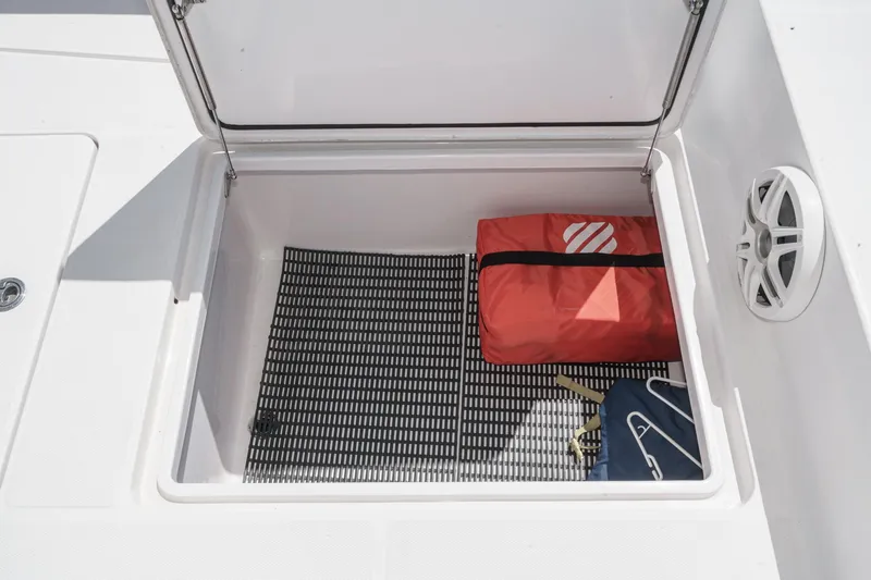 Slide: The Image of Open storage compartment on 2019 Fountain 38 CC boat with bags inside. - 41
