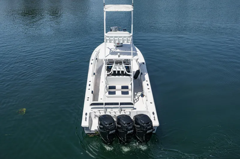 Slide: The Image of 2019 Fountain 38 CC boat with triple Mercury engines on calm water. - 47