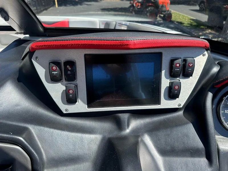 Slide: The Image of Dashboard of a 2021 Supreme ZS212 boat with control switches and display screen. - 21