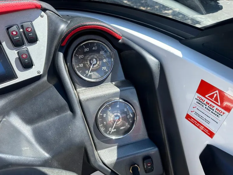 Slide: The Image of Dashboard of a 2021 Supreme ZS212 boat with speedometer and warning label. - 22