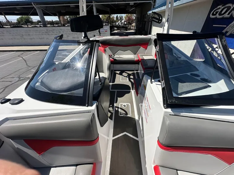 Slide: The Image of 2021 Supreme ZS212 boat interior with gray and red seating, open cockpit view. - 28