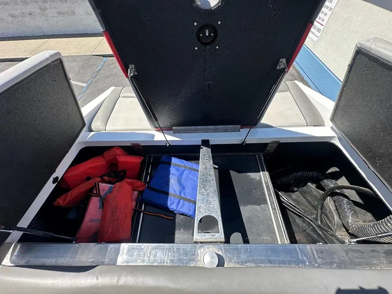 Slide: The Image of Open storage compartment of 2021 Supreme ZS212 boat with life jackets and equipment. - 29