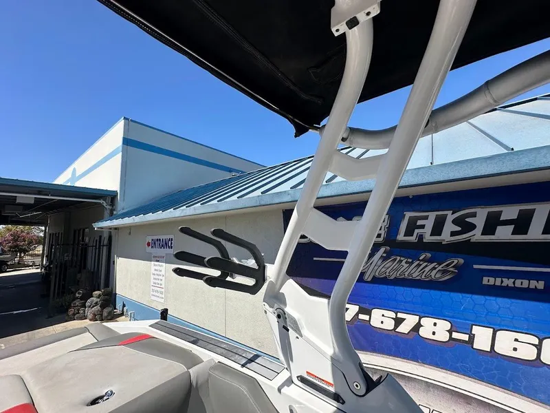 Slide: The Image of 2021 Supreme ZS212 boat near a marine service entrance with blue signage. - 30