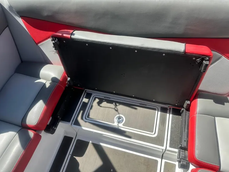 Slide: The Image of 2021 Supreme ZS212 boat interior with red and gray seating and storage compartment. - 31