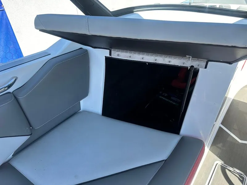 Slide: The Image of 2021 Supreme ZS212 boat interior with gray seating and storage compartment. - 33