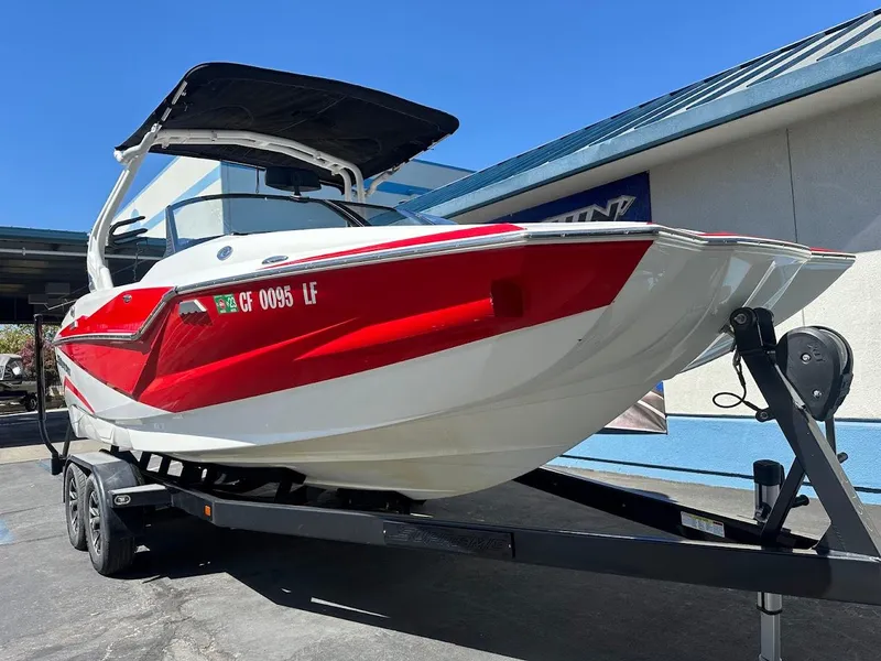 Slide: The Image of Red and white 2021 Supreme ZS212 boat on trailer, parked outdoors. - 5