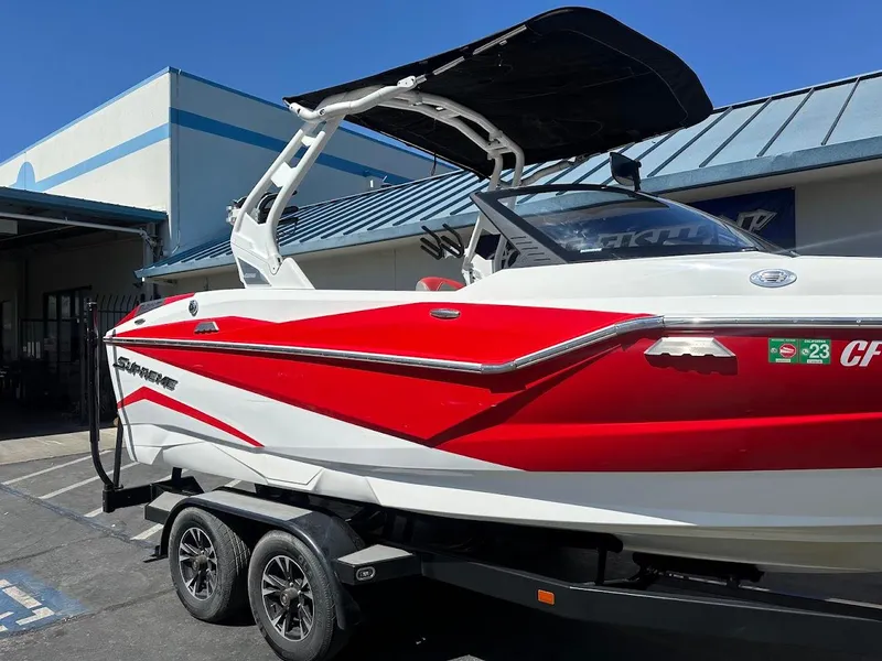 Slide: The Image of 2021 Supreme ZS212 boat with red and white design on a trailer. - 6