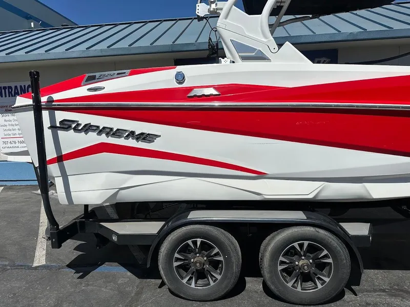 Slide: The Image of 2021 Supreme ZS212 boat with red and white design on a trailer. - 7