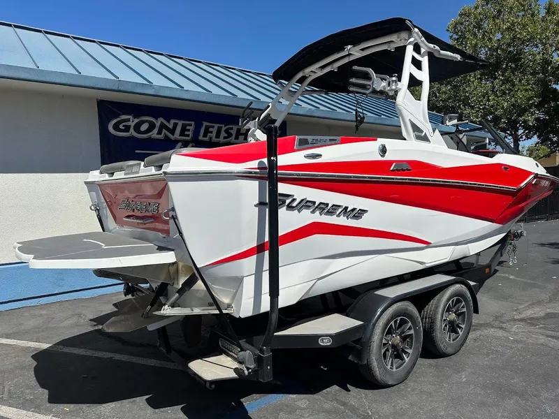 Slide: The Image of 2021 Supreme ZS212 boat with red and white design on a trailer. - 8