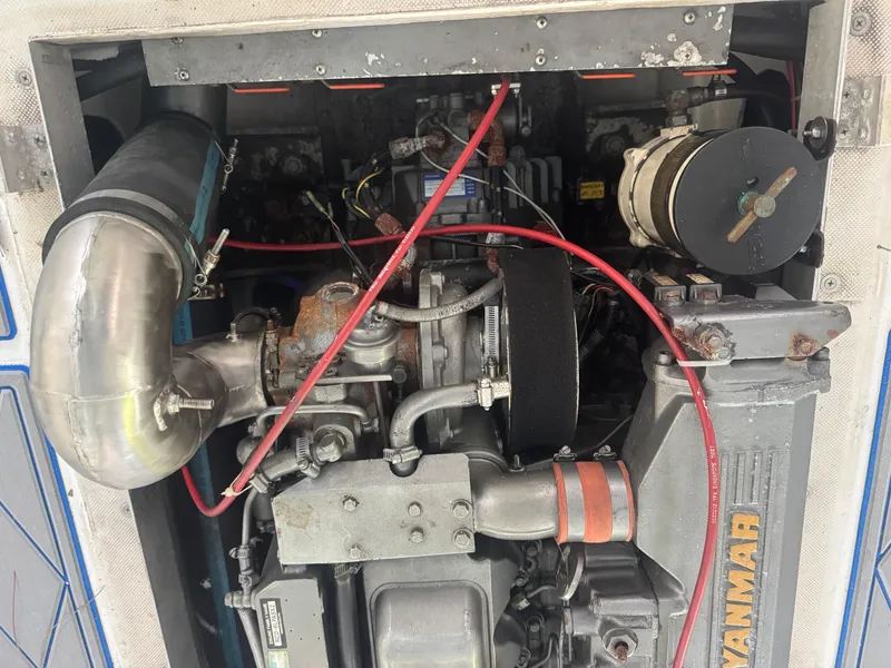 Slide: The Image of Engine compartment of a 2012 Ocean Runner 290i boat, featuring a Yanmar engine. - 16