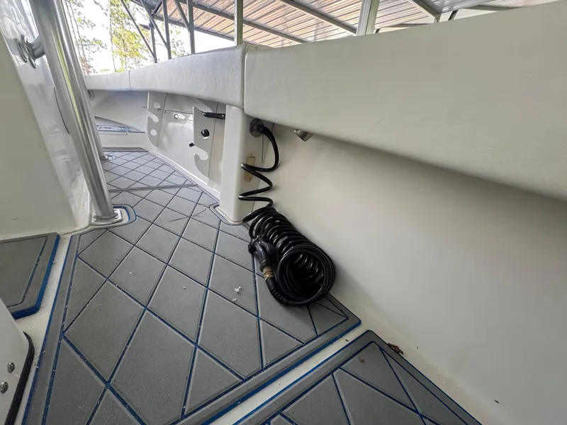 Slide: The Image of Interior view of 2012 Ocean Runner 290i boat with coiled hose and non-slip flooring. - 18