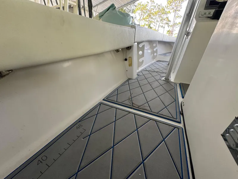 Slide: The Image of Interior view of 2012 Ocean Runner 290i boat with cushioned seating and patterned flooring. - 19