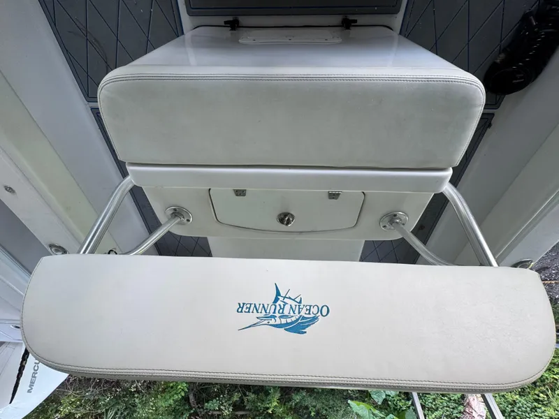 Slide: The Image of Ocean Runner 290i boat seat with logo, 2012 model, featuring white upholstery and metal supports. - 23