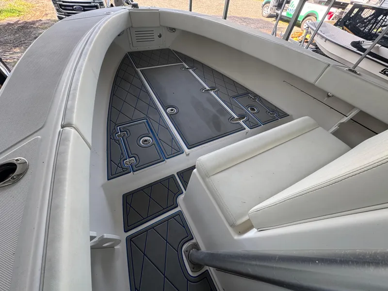 Slide: The Image of Interior of a 2012 Ocean Runner 290i boat, featuring cushioned seating and non-slip flooring. - 27