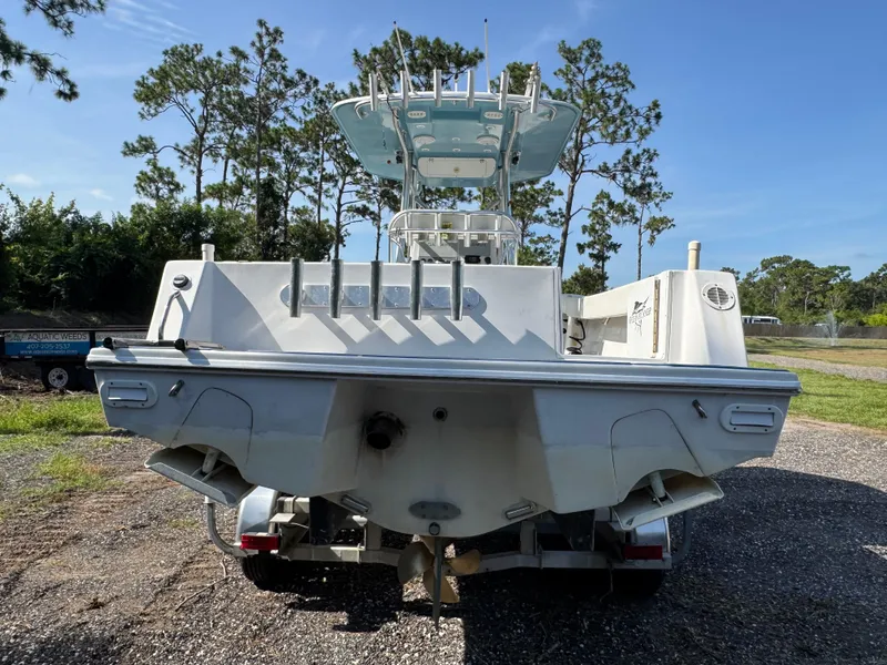 Slide: The Image of 2012 Ocean Runner 290i boat on trailer, surrounded by trees and clear sky. - 4
