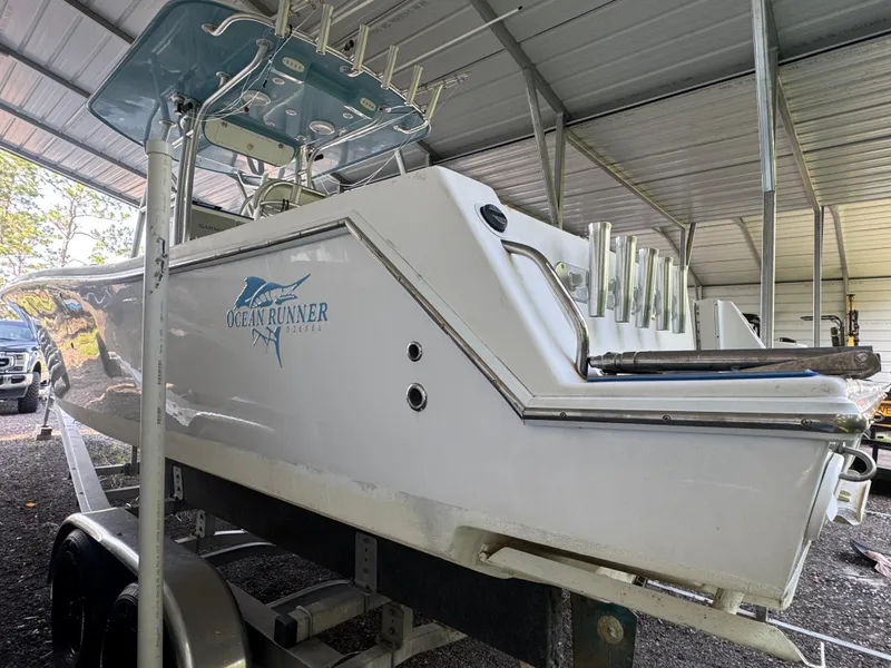 Slide: The Image of 2012 Ocean Runner 290i boat in covered storage, side view with logo visible. - 6