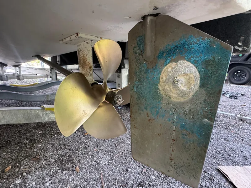 Slide: The Image of Close-up of Ocean Runner 290i boat propeller and rudder, 2012 model, on gravel surface. - 7