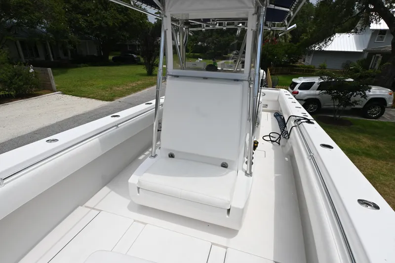 Slide: The Image of 2009 Contender 35 ST boat interior with seating and console, parked in a residential area. - 10