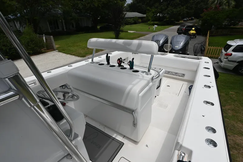 Slide: The Image of 2009 Contender 35 ST boat interior with helm, rod holders, and seating. - 11