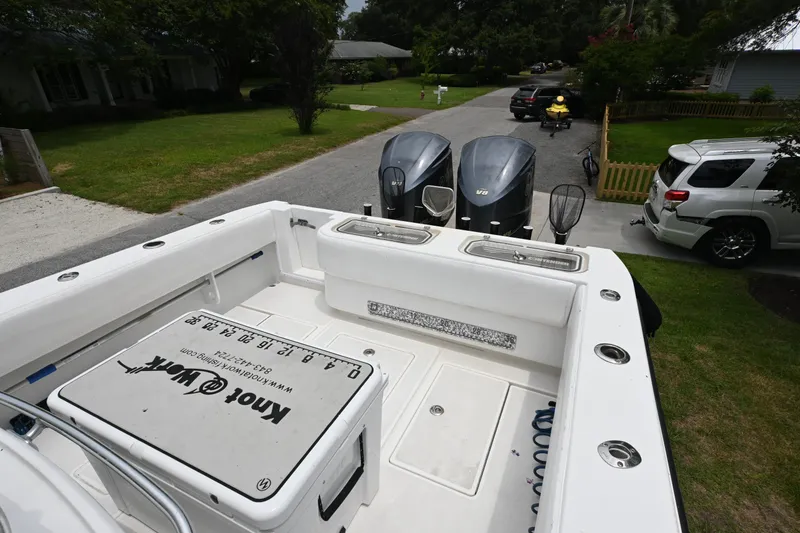 Slide: The Image of 2009 Contender 35 ST boat with dual engines parked in a residential driveway. - 12