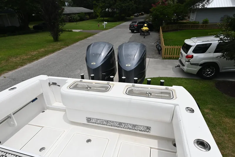 Slide: The Image of 2009 Contender 35 ST boat with dual V6 engines parked in a residential driveway. - 13