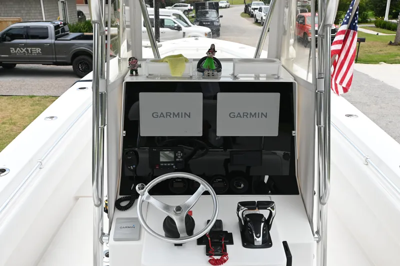 Slide: The Image of 2009 Contender 35 ST boat dashboard with Garmin displays and American flag. - 16