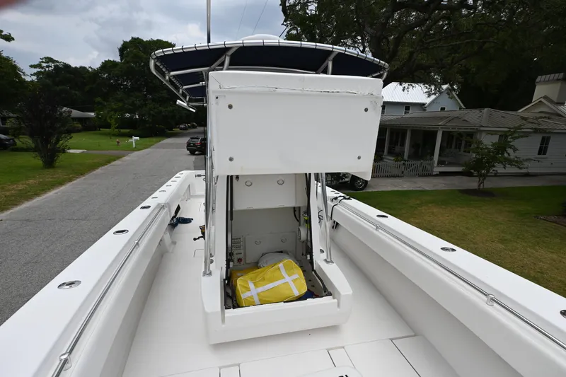 Slide: The Image of 2009 Contender 35 ST boat with open storage compartment on a residential street. - 18