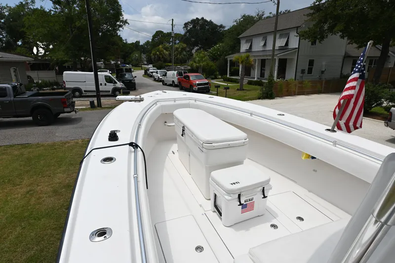 Slide: The Image of 2009 Contender 35 ST boat with coolers and American flag, parked in a residential area. - 7