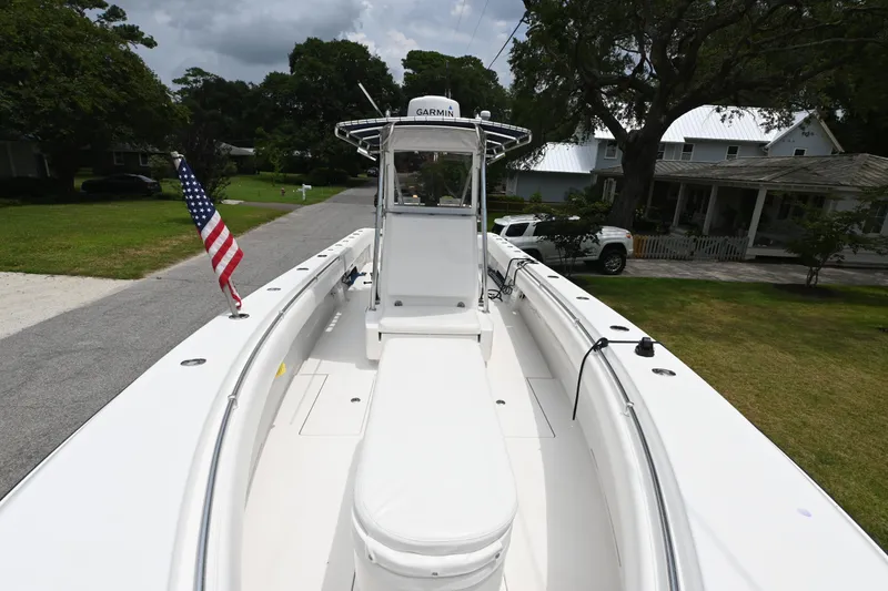 Slide: The Image of 2009 Contender 35 ST boat with American flag, parked on a residential street. - 8