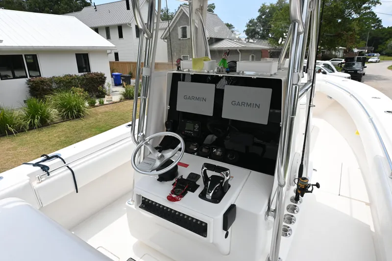Slide: The Image of 2009 Contender 35 ST boat cockpit with Garmin navigation displays and steering wheel. - 9