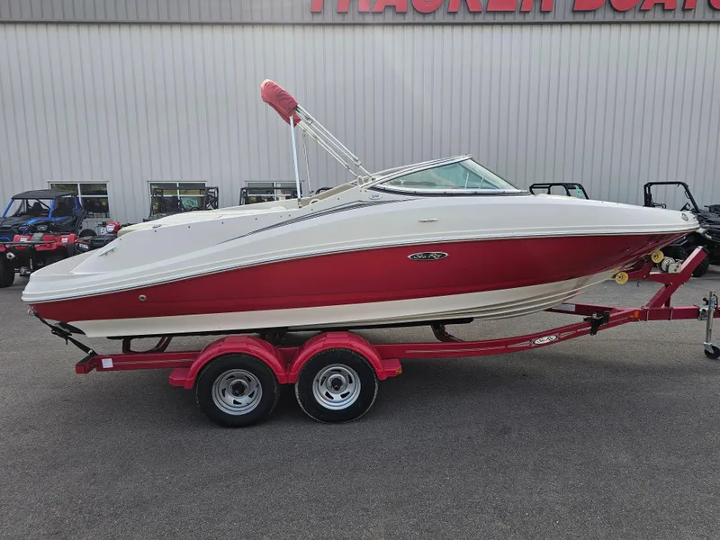 The Image of 2007 Sea Ray 210 Select boat on red trailer, parked outside dealership. - 0