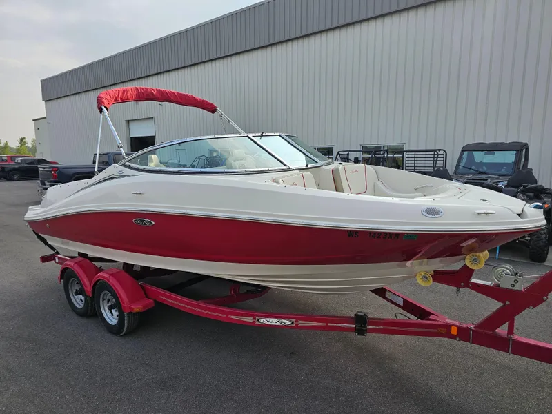Slide: The Image of 2007 Sea Ray 210 Select boat with red and white design on a trailer. - 1