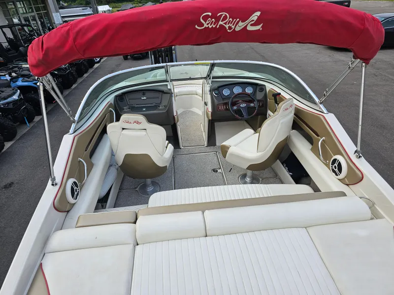 Slide: The Image of 2007 Sea Ray 210 Select boat interior with red canopy and white seating. - 10