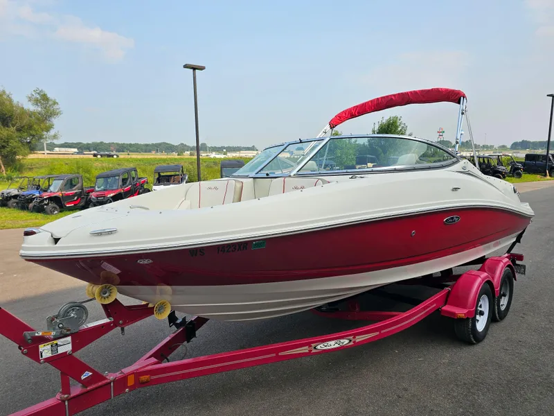Slide: The Image of 2007 Sea Ray 210 Select boat on a red trailer, parked outdoors. - 2