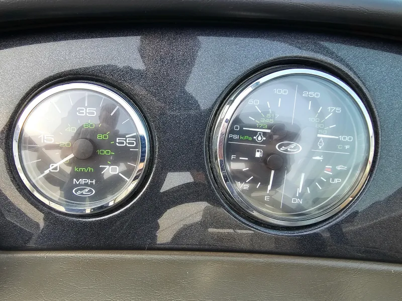 Slide: The Image of Dashboard gauges of a 2007 Sea Ray 210 Select boat, showing speed and engine metrics. - 20