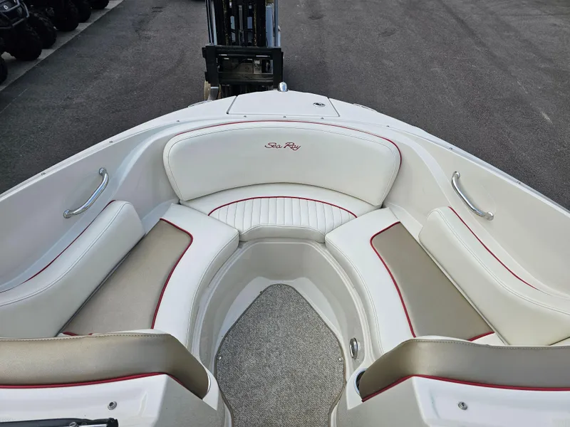 Slide: The Image of 2007 Sea Ray 210 Select boat interior with white and beige seating, red accents. - 23
