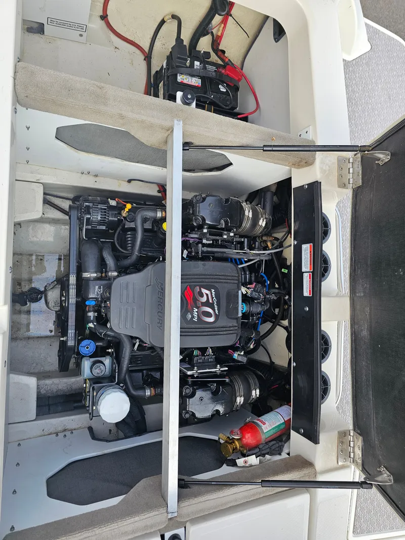 Slide: The Image of 2007 Sea Ray 210 Select engine compartment with MerCruiser 5.0L engine and battery. - 27