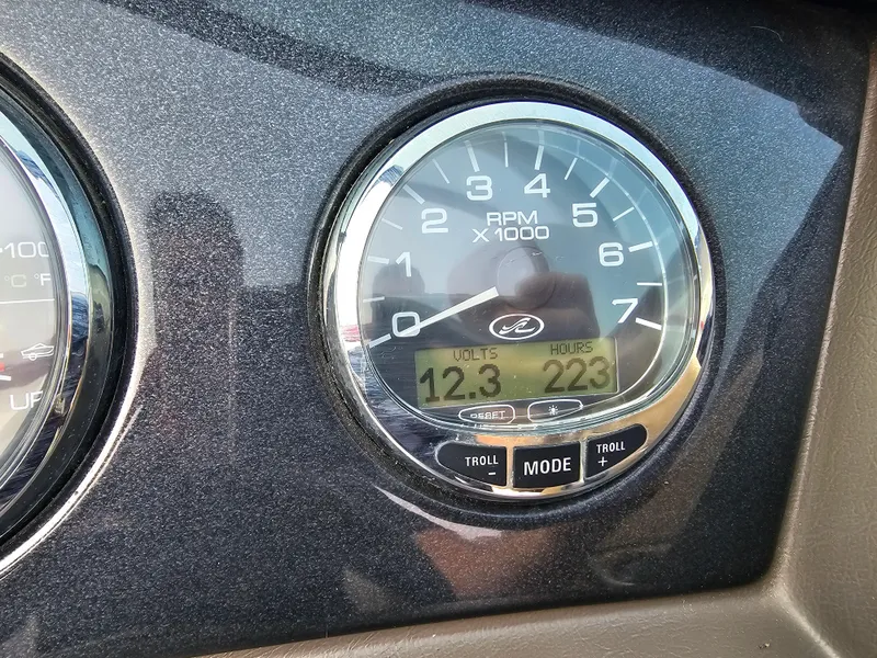 Slide: The Image of Close-up of 2007 Sea Ray 210 Select tachometer showing 12.3 volts and 223 hours. - 28